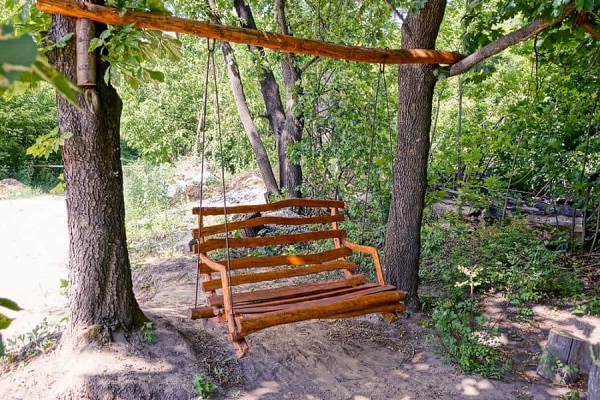 A swing hanging between two trees