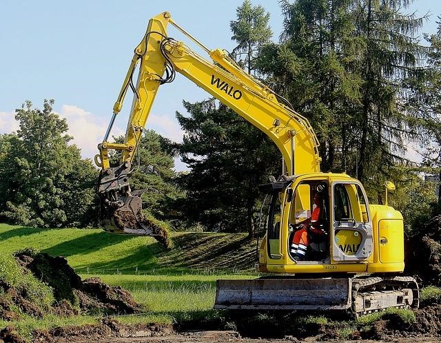 Excavator at work in digging the soil 