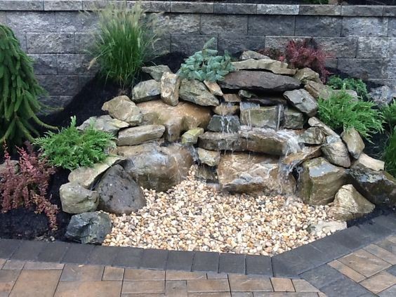 A mini waterfall using rocks in a pondless design. 