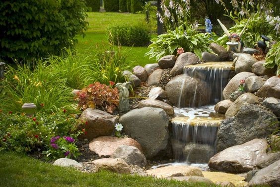 A water garden designed with flat stones to deliver smooth 
flowing water in a pondless system.
