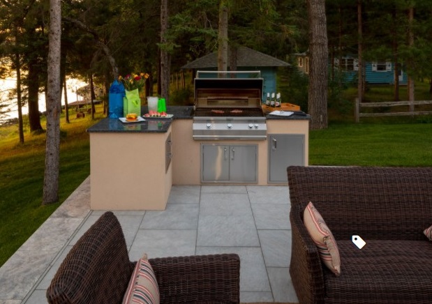 An outdoor kitchen surrounded by tall pine trees