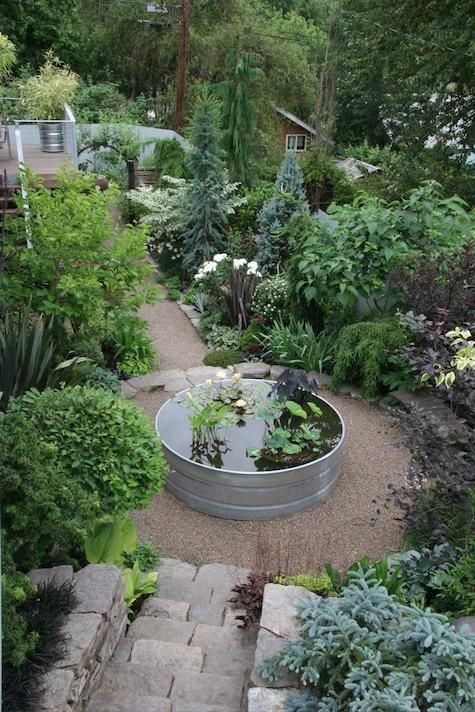 A galvanized koi pond serving as a rotunda in a garden. 