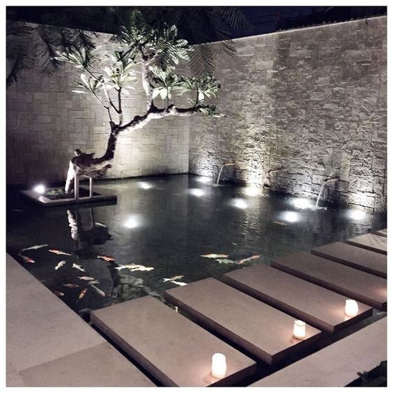 A koi pond designed with pale stone colors from a modern perspective. 