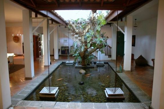 A koi pond that fills the whole courtyard with one specimen tree and four water ornaments.