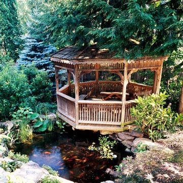 A medium-sized pagoda tucked under the shade of a pine tree. 