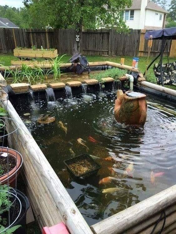 A mini raised koi pond with a single-tier waterfall 