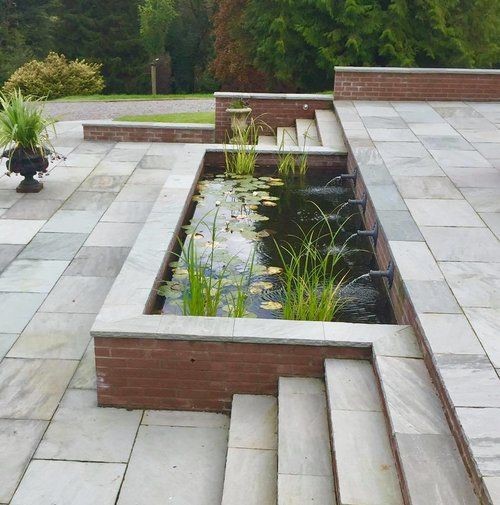 A simple koi pond that adds life at the center of bare outdoor stairs.