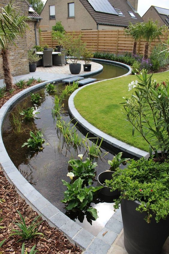 A water garden/koi pond that breaks up the traditional lawn design by using an S-shape pond.
