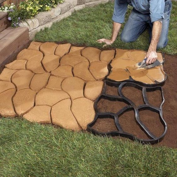 An orange-colored concrete molded into irregularly-shaped stepping stones. 