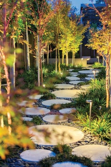 A garden path made of white concrete slabs in different sizes.