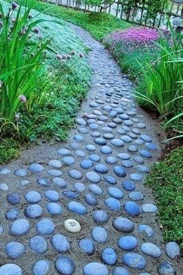A pathway made of pebbles submerged in concrete.