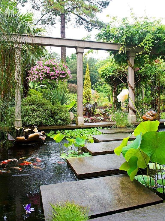 A water garden/koi pond that uses cleanly-cut rectangle concrete slabs as stepping stones across the pond.