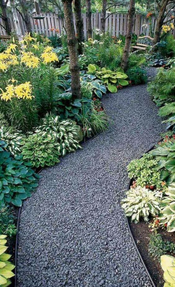 A simple pathway designed with bluestone gravel and metal edging.