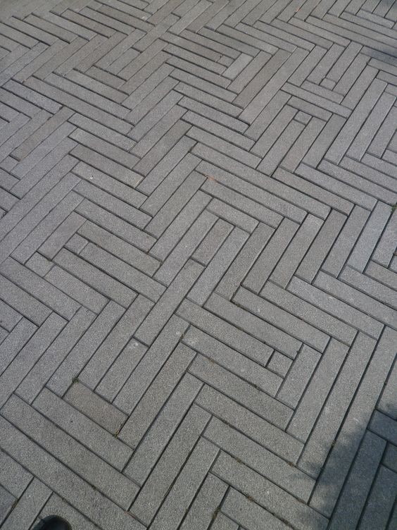 A pathway made of rubber paver blocks designed in an eye-illusion pattern.