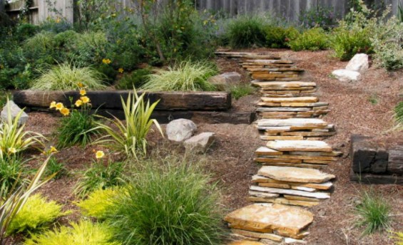 A stack of thin slabs of stones turned into steps of the stairs in the garden.