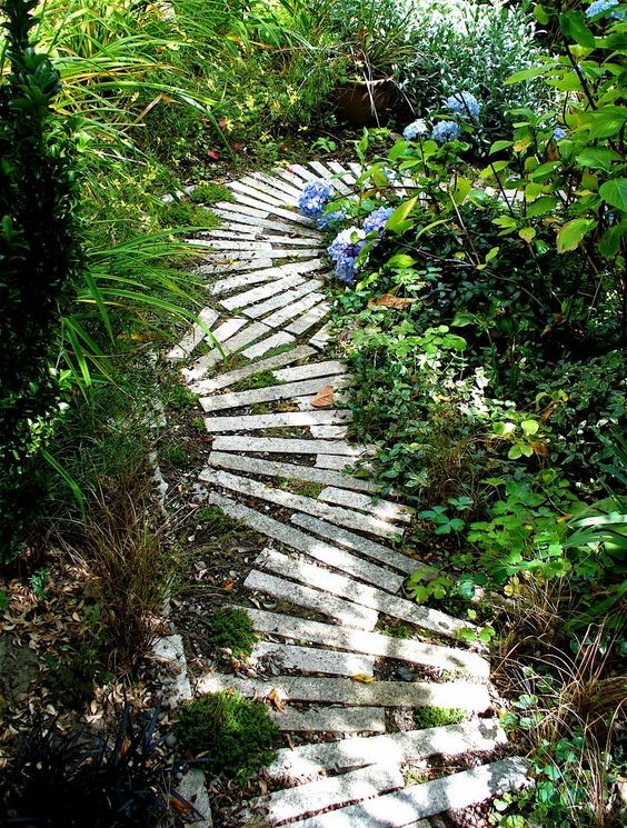 The thin slate stones are placed in a semi-circle pattern alternately placed along the garden path.