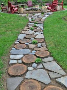 A garden pathway that uses the element of wood and bluestone carved in different shapes to create an abstract pattern.