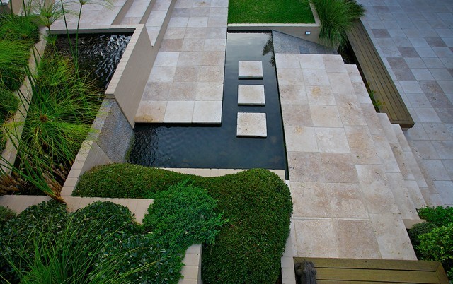 A contemporary-designed garden full of travertine stones.