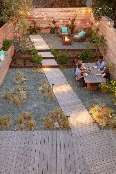 A modern pathway design that stretches from the patio to the outdoor deck at the end of the garden.
