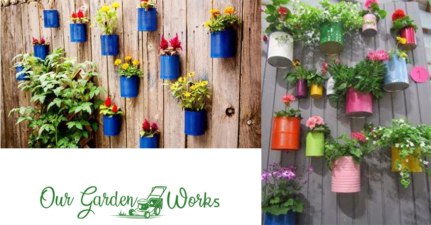 Colored tin cans used as hanging fence planters.