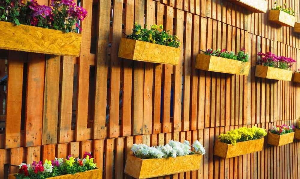 Fence planter boxes hanging on the fence.