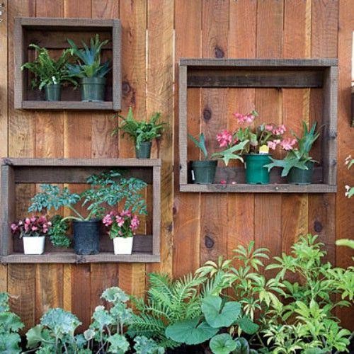 Framed pots attached to the fence.
