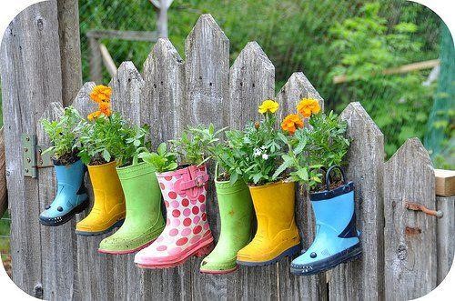 Repurposed Boots as fence planters.